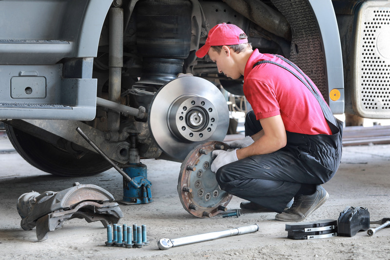 A,Mechanic,Repairs,A,Truck.,Replace,Brake,Disc,And,Pads